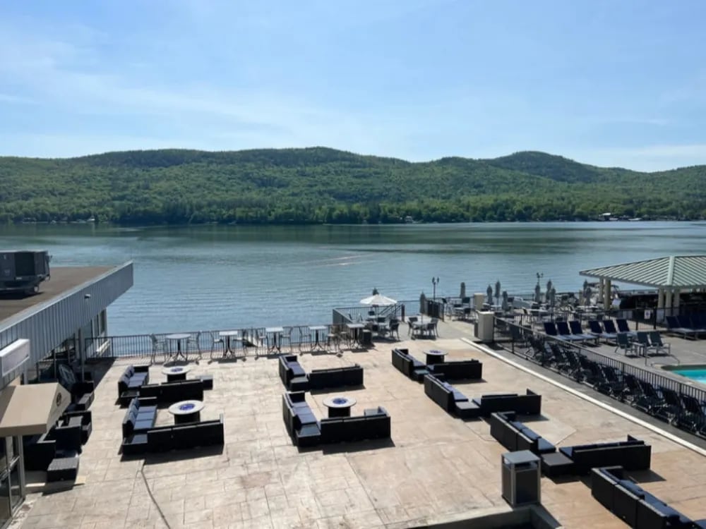 View from a covered motel porch looking out to the lake, docks, and mountains