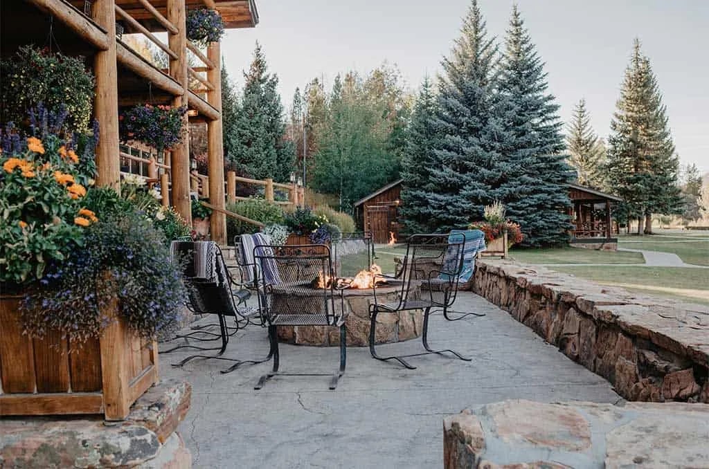 Fireside Terrace outside the Main Lodge with a fire pit and Adirondack chairs.