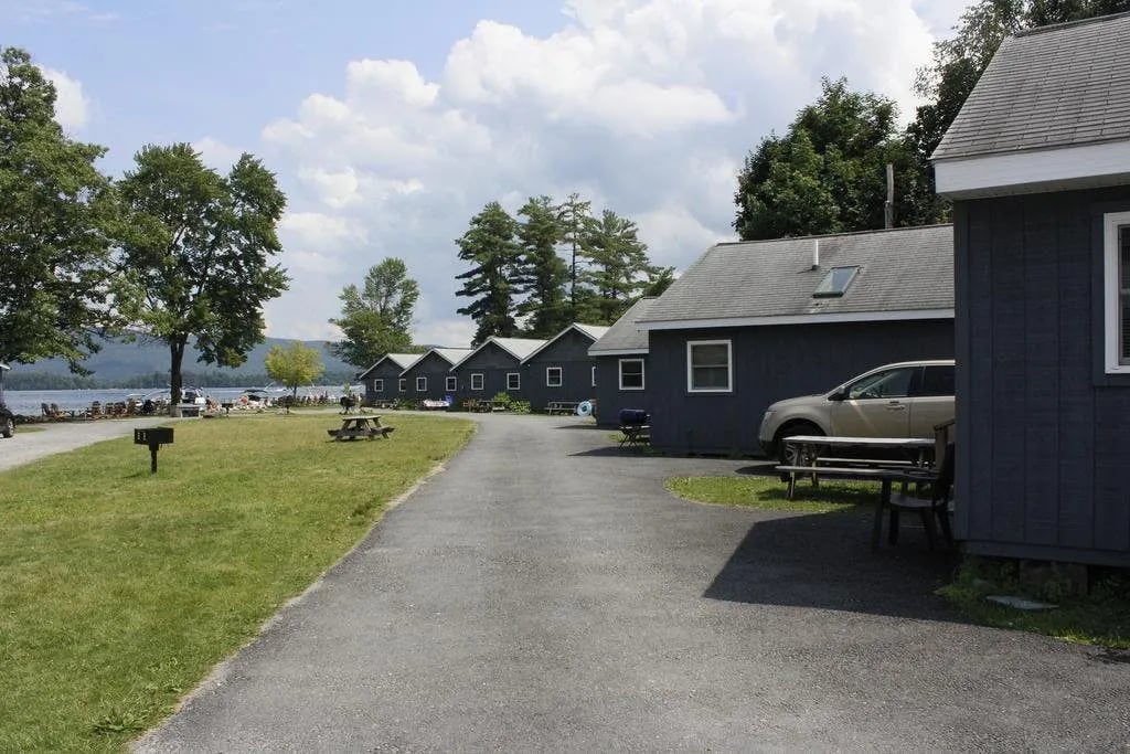 Row of Lake View Cottages with a paved road leading to the lake