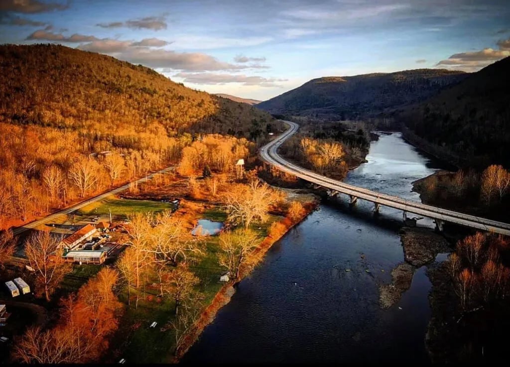 Aerial view of Beaver-Del property, river, and bridge in autumn