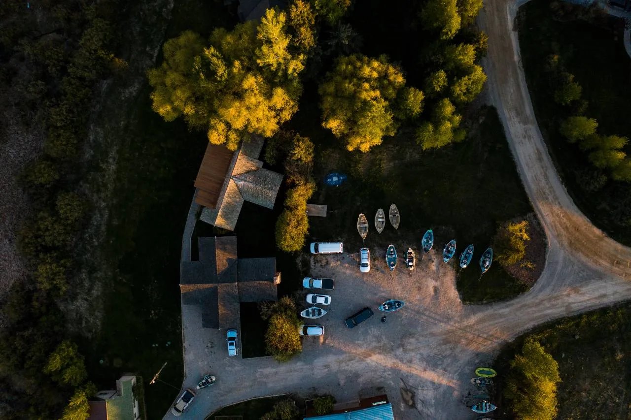 Aerial view of Teton Valley Lodge compound with multiple drift boats parked