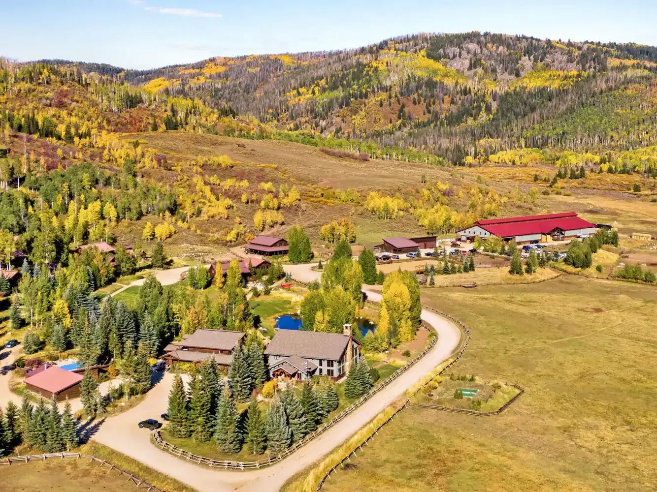 Aerial view of Vista Verde Ranch facilities nestled in a valley with fall foliage