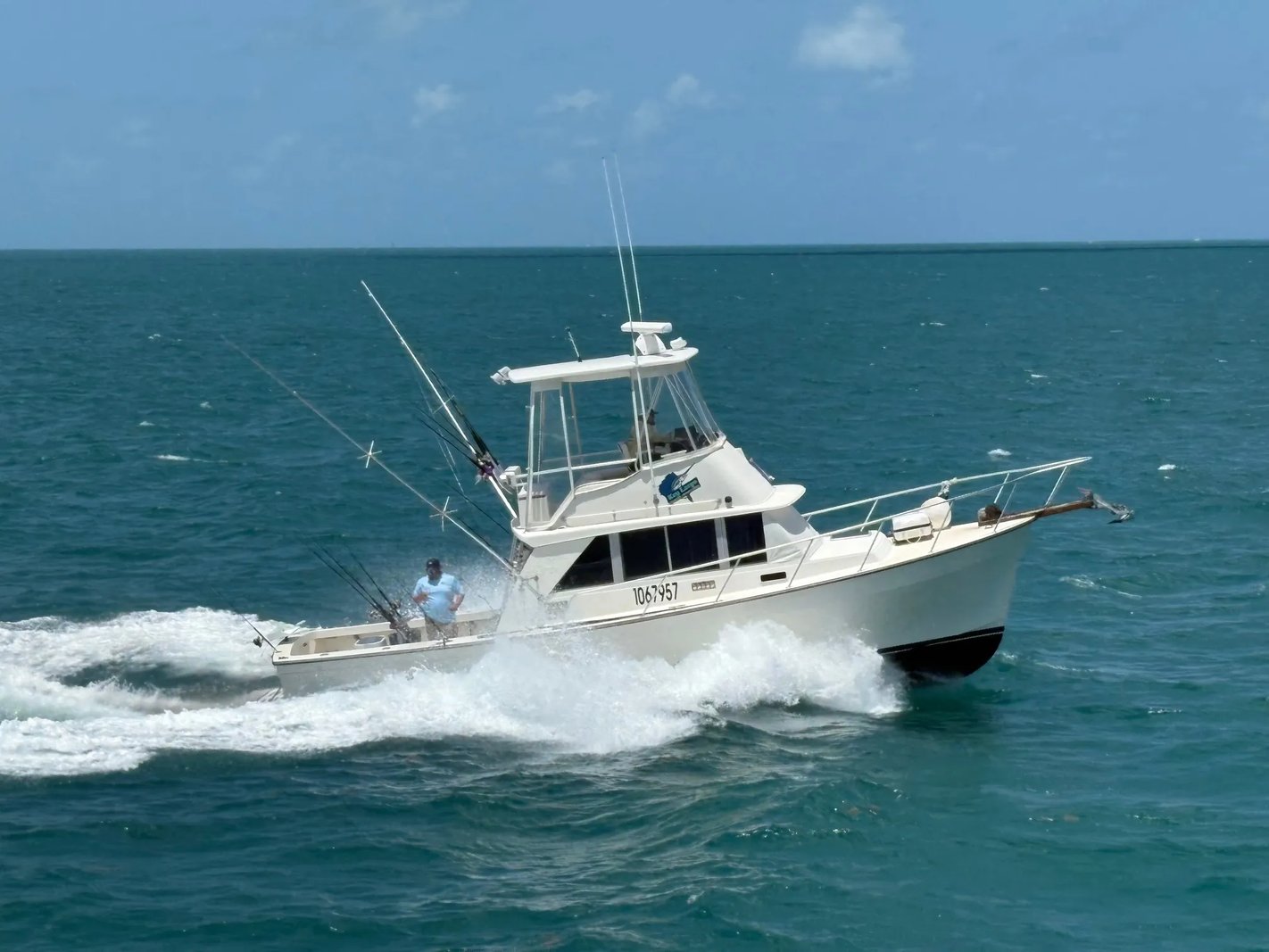 White sportfishing boat 'No Fear' running on choppy blue water.