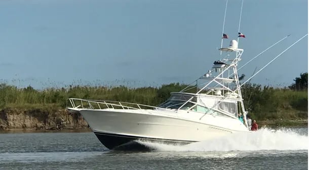 Collage of a white sportfishing boat on blue water and an aerial view of the boat.