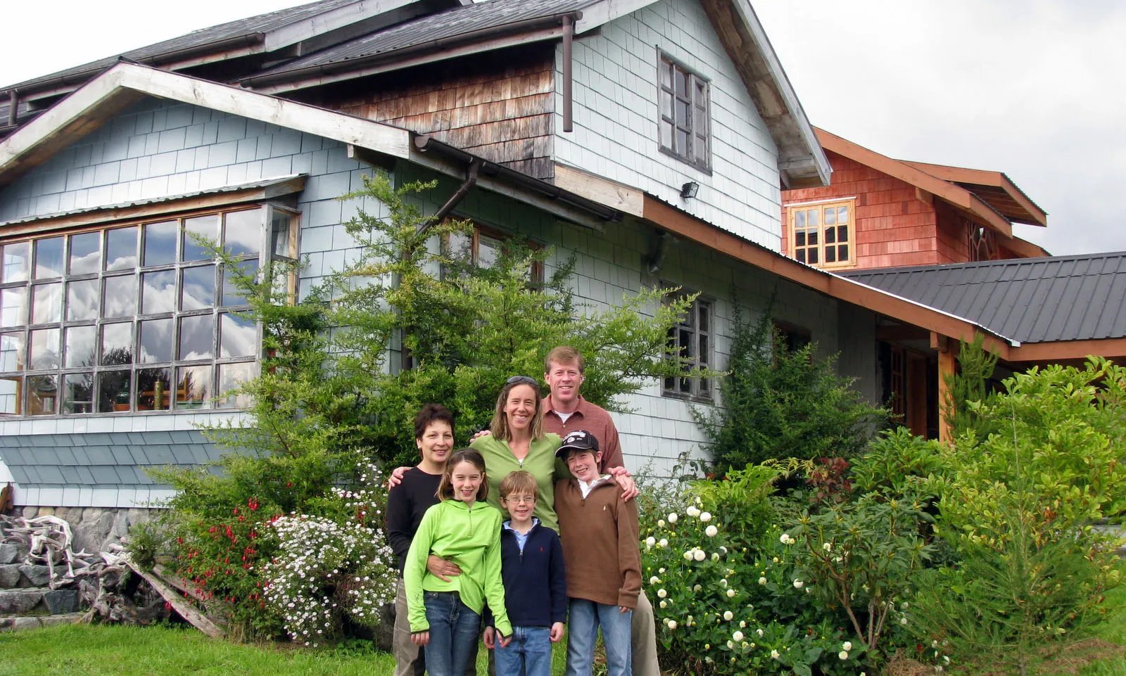 Family posing in front of the main Tres Rios Lodge building.