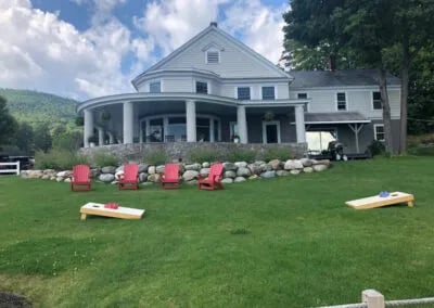Main lodge building from the water with docks, jet skis, and boats on a sunny day