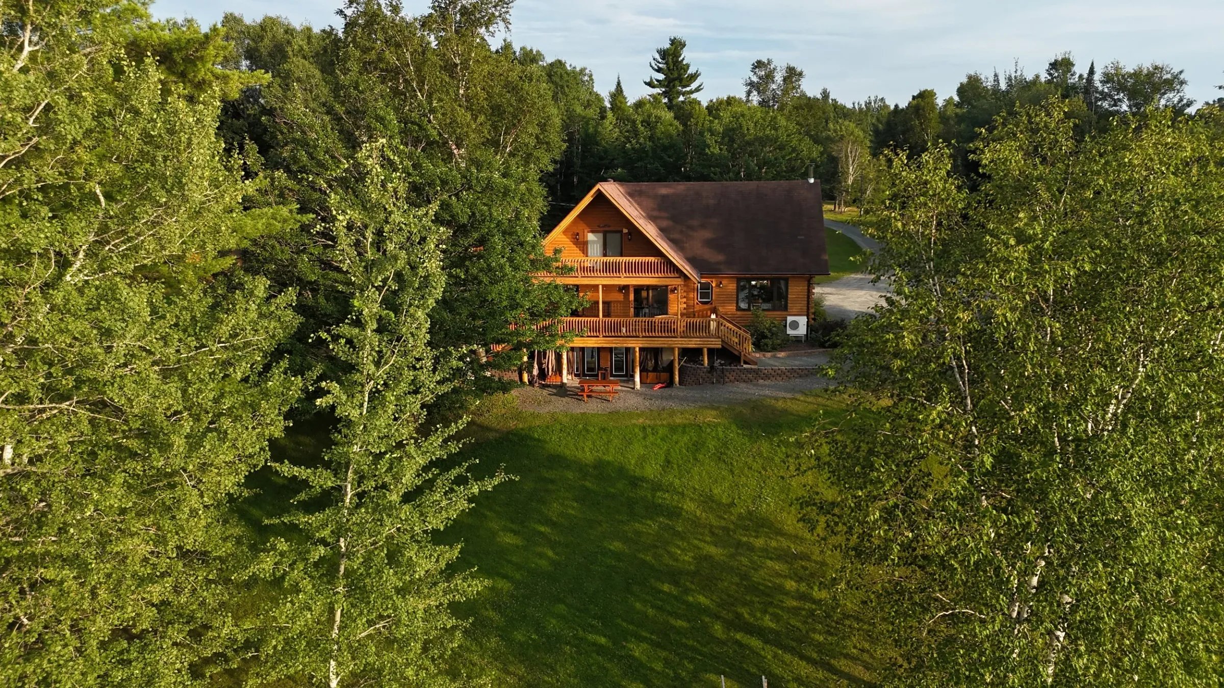 Aerial view of the main Lodge of Country Haven Lodge on the riverfront of the Miramichi River in Canada.