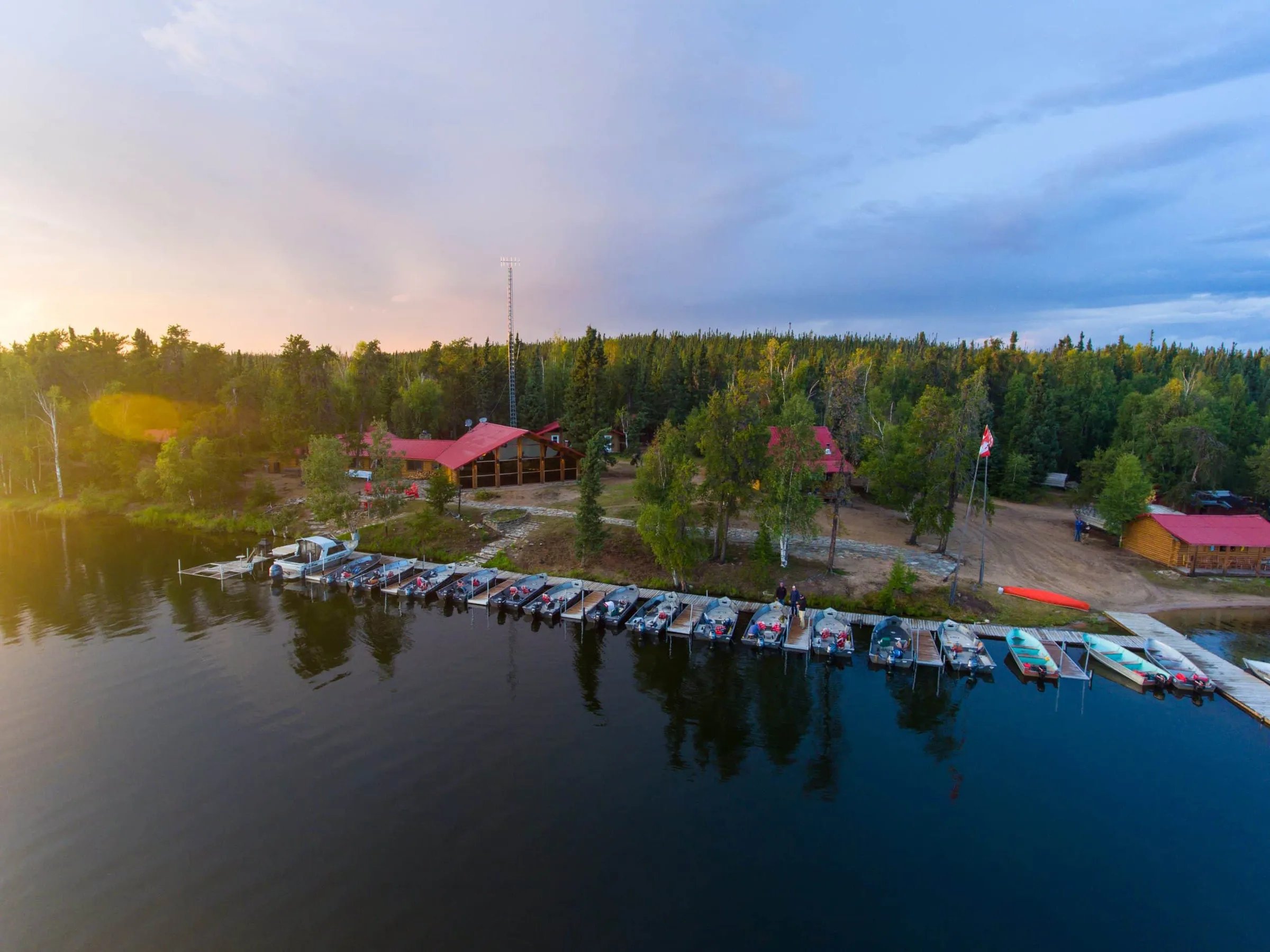 Aerial view of the lodge compound with docks and boats at sunset