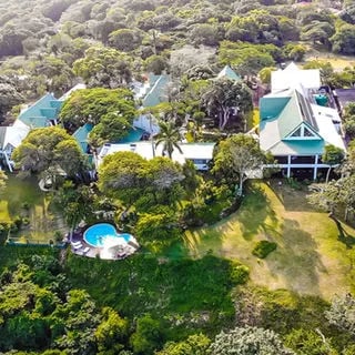 Aerial view of St. Lucia Eco Lodge property with green roofs and swimming pool