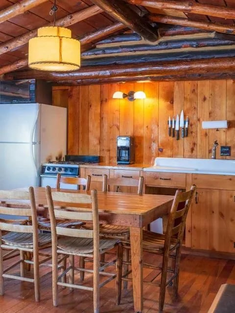 Kitchen with sink, gas stove, and table and chairs for 6 people