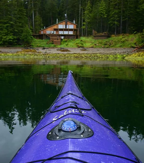 the west coast fishing club - blue kayak in water