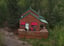 Deluxe Executive Cabin exterior with red awnings and a large wooden deck in a forest setting