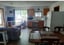 Living room and kitchenette with a dining table and a view of the lake