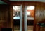 View through two open doorways into separate bedrooms with queen beds