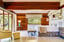 Spacious villa bedroom with a king-size bed, wooden ceiling, and large windows