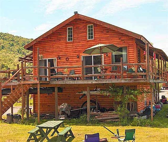Onteora Loft cabin by the water with vibrant fall foliage