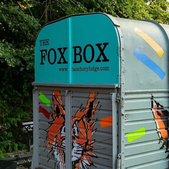 The Fox Box food trailer with a teal top and fox artwork on the side