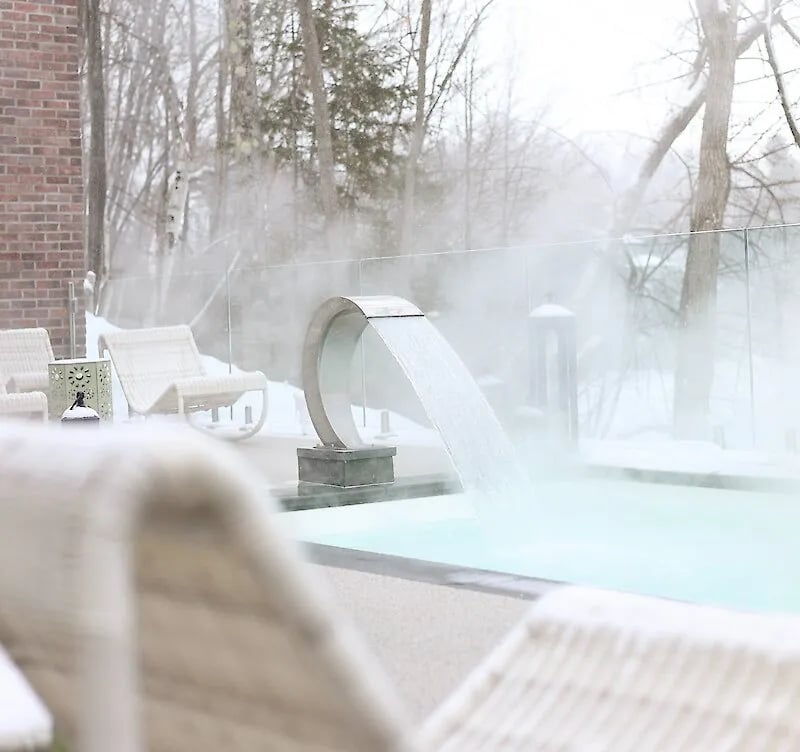 A waterfall and hot tub in the winter