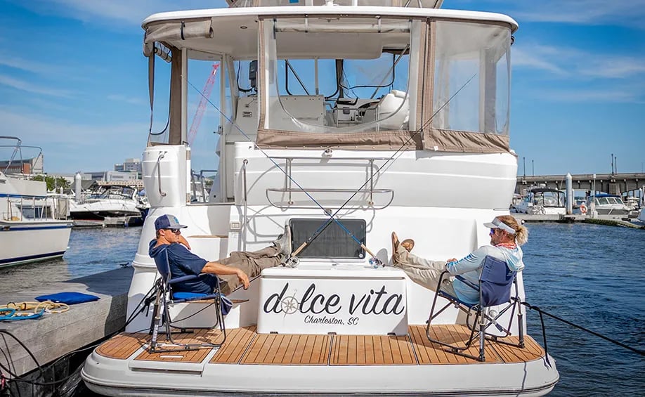 Stern of the 'Dolce Vita' yacht with two people relaxing in chairs